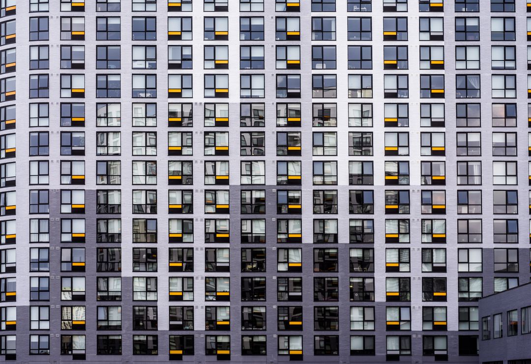 Modern Urban Apartment Building With Grid-Patterned Windows - Free Images, Stock Photos and Pictures on Pikwizard.com