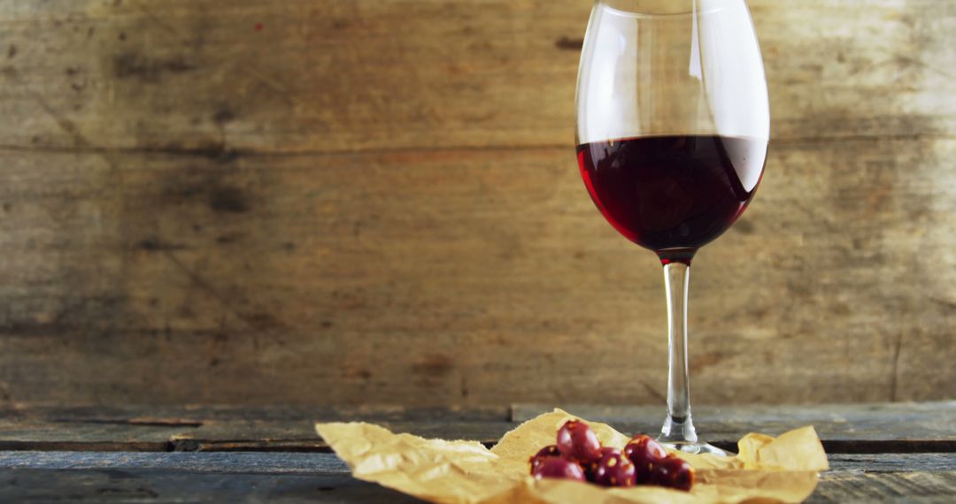 Glass of Red Wine with Grapes on Rustic Wooden Background - Free Images, Stock Photos and Pictures on Pikwizard.com