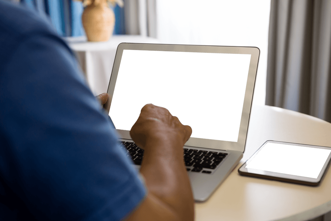 Senior Man with Transparent Laptop Screen in Nursing Home Setting