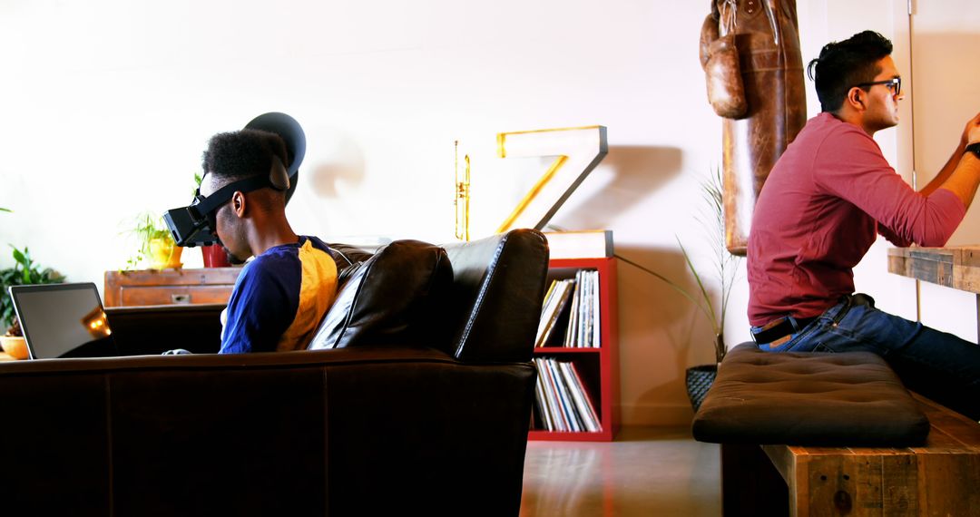 Two Young Men Engaging in VR and Digital Technology in Modern Living Room - Free Images, Stock Photos and Pictures on Pikwizard.com