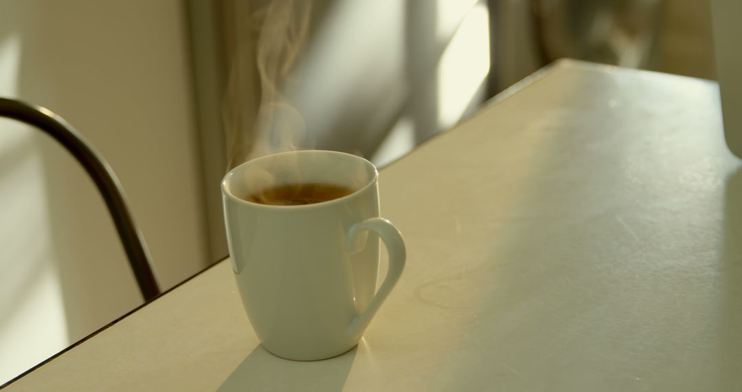 Steaming Mug of Coffee on Kitchen Table - Free Images, Stock Photos and Pictures on Pikwizard.com