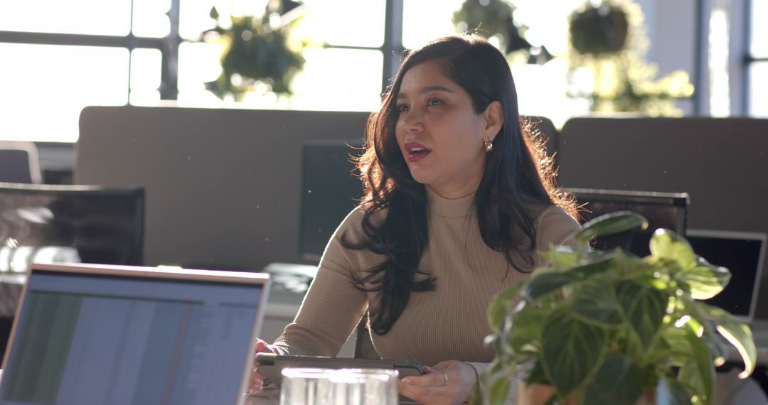 Leading Team Discussion in Modern Office with Tablet and Laptop