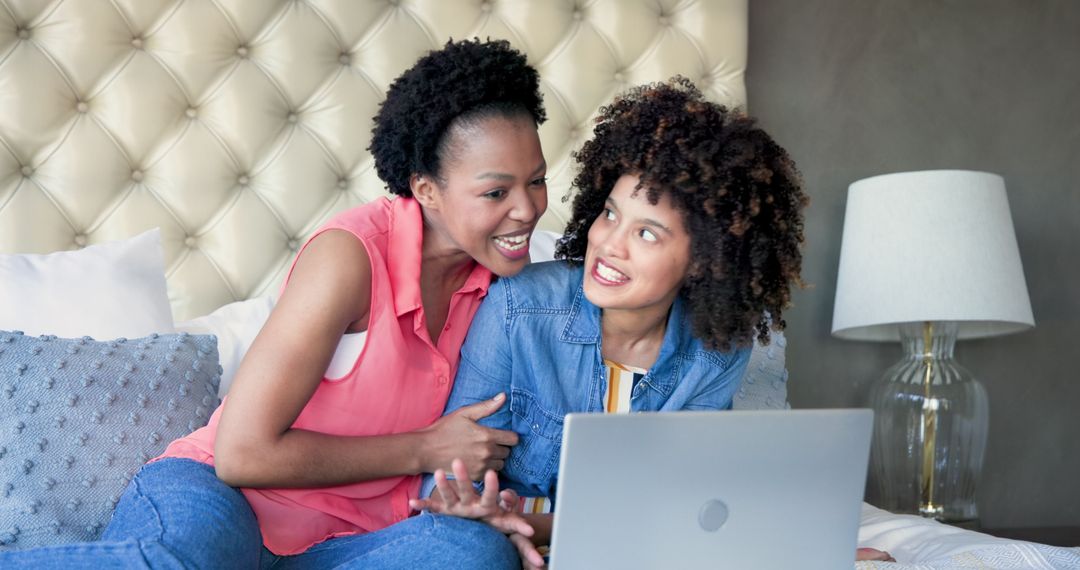 Friends Laughing Together Using Laptop at Home