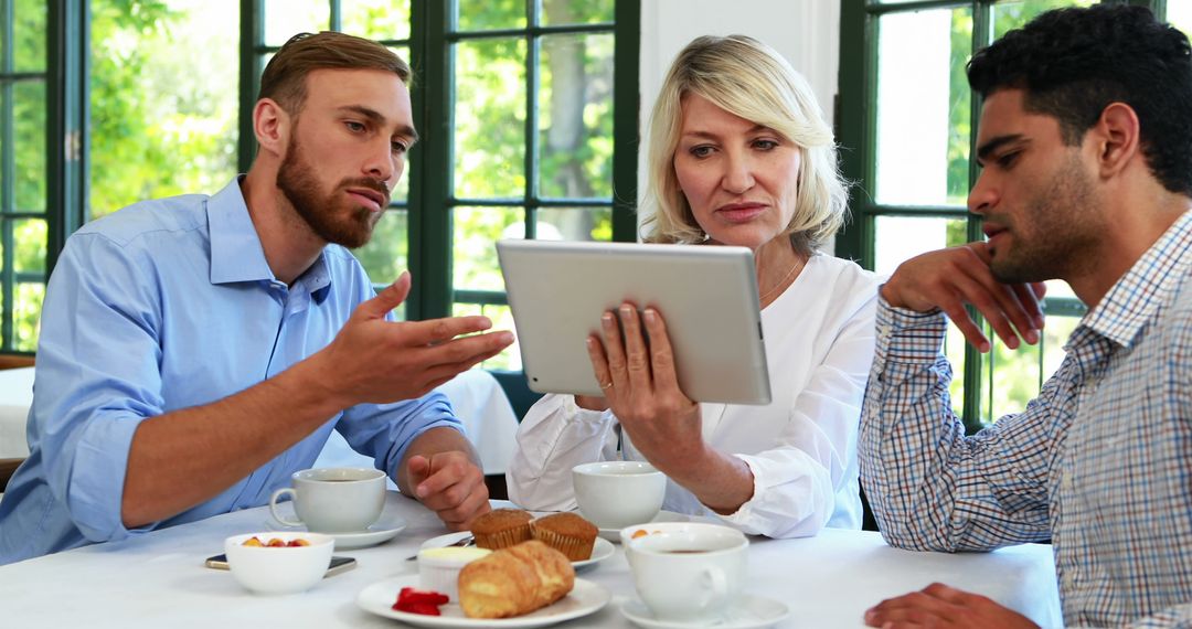 Team Collaboration on Tablet During Coffee Break