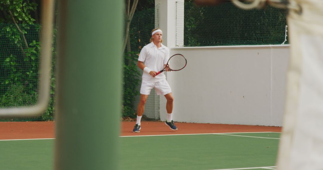 Young Tennis Player Preparing for Return on Outdoor Hard Court - Free Images, Stock Photos and Pictures on Pikwizard.com