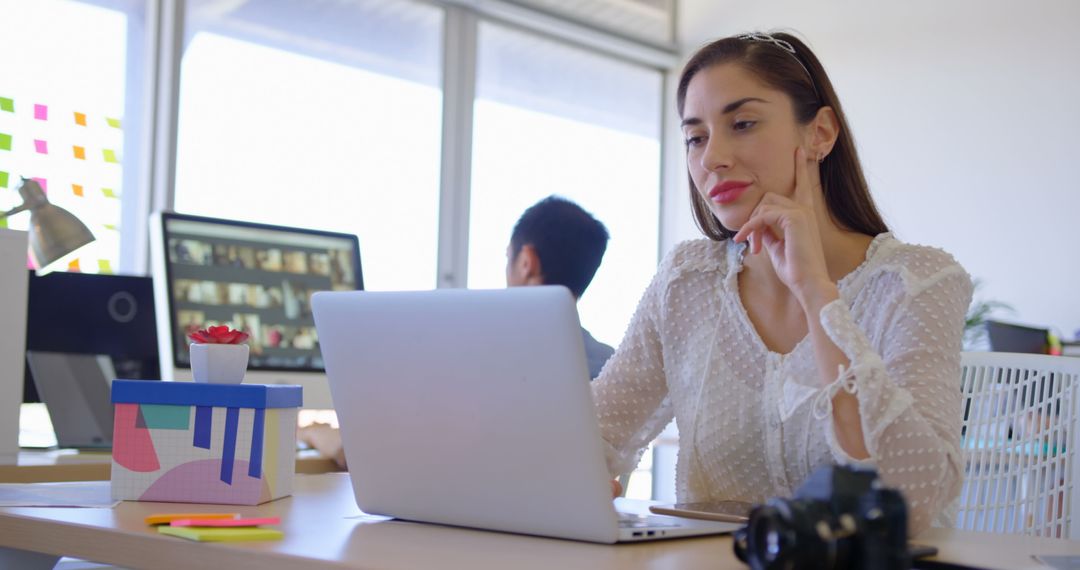 Confident Young Professional Woman Working on Laptop in Modern Office