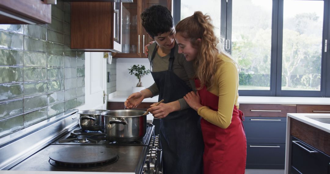 Happy Couple Cooking Together in Modern Kitchen with Large Windows - Free Images, Stock Photos and Pictures on Pikwizard.com