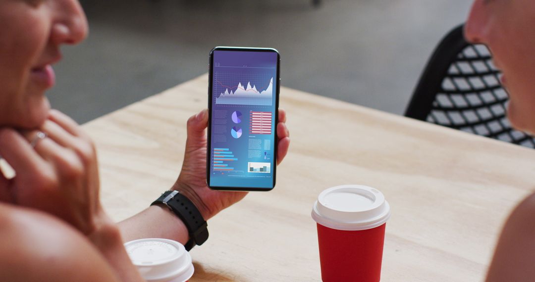 Colleagues Discussing Data Insights on Smartphone