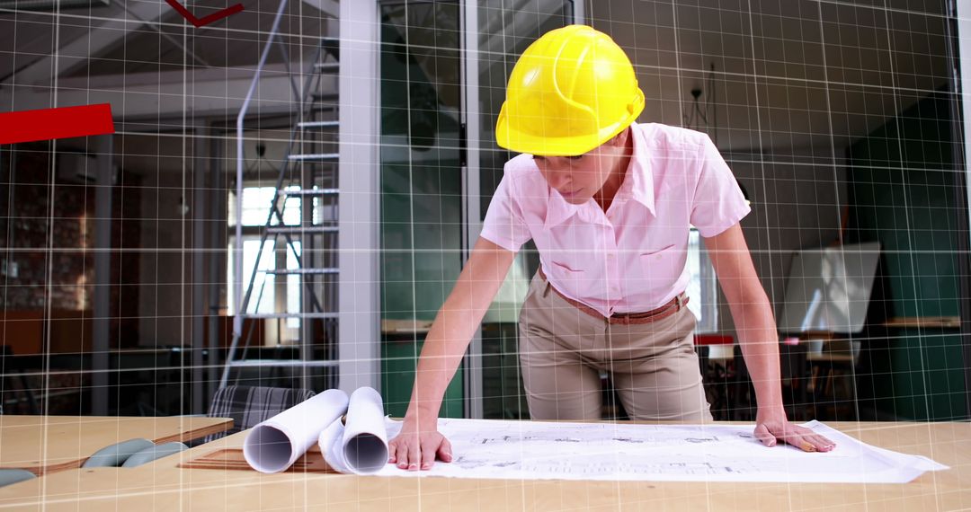 Engineer Analyzing Architectural Plans with Digital Overlay