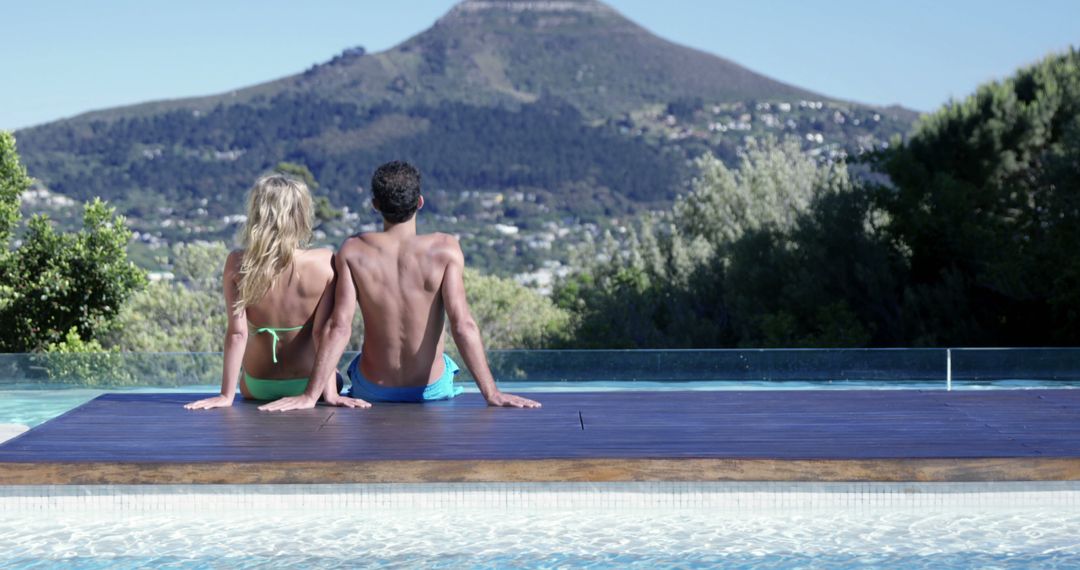 Couple Relaxing by Infinity Pool with Mountain View - Free Images, Stock Photos and Pictures on Pikwizard.com