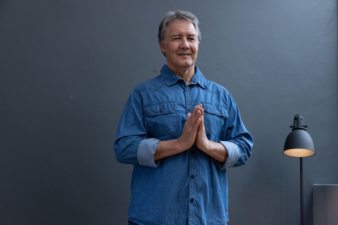 Senior Man Embracing Tranquility in Minimalistic Studio Environment