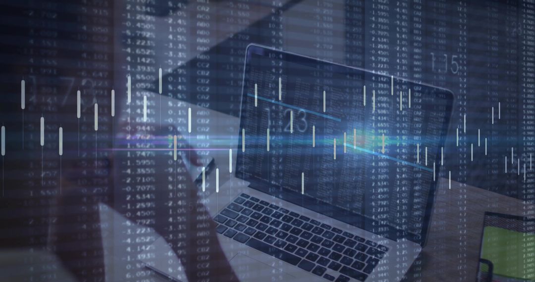 Laptop with candlestick charts overlay showing trading analysis on office desk
