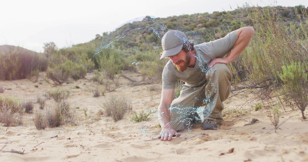 Explorer Interacting with Technology in Wild Desert Landscape