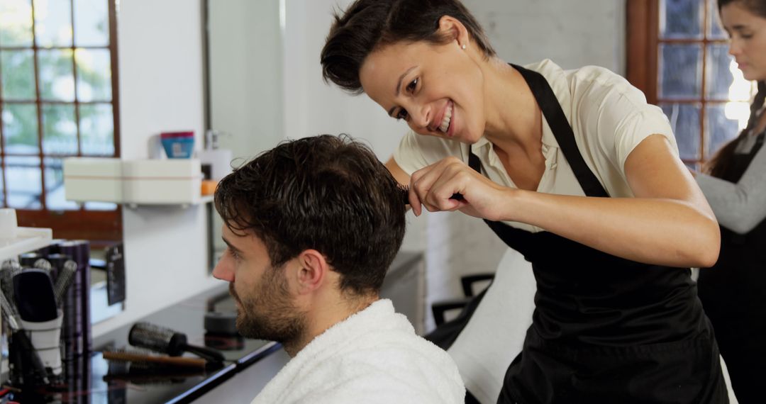 Smiling Hairdresser Cutting Male Client's Hair in Salon - Free Images, Stock Photos and Pictures on Pikwizard.com