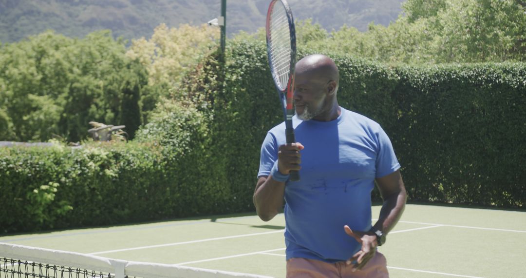 Mature Man Playing Tennis on Outdoor Court - Free Images, Stock Photos and Pictures on Pikwizard.com