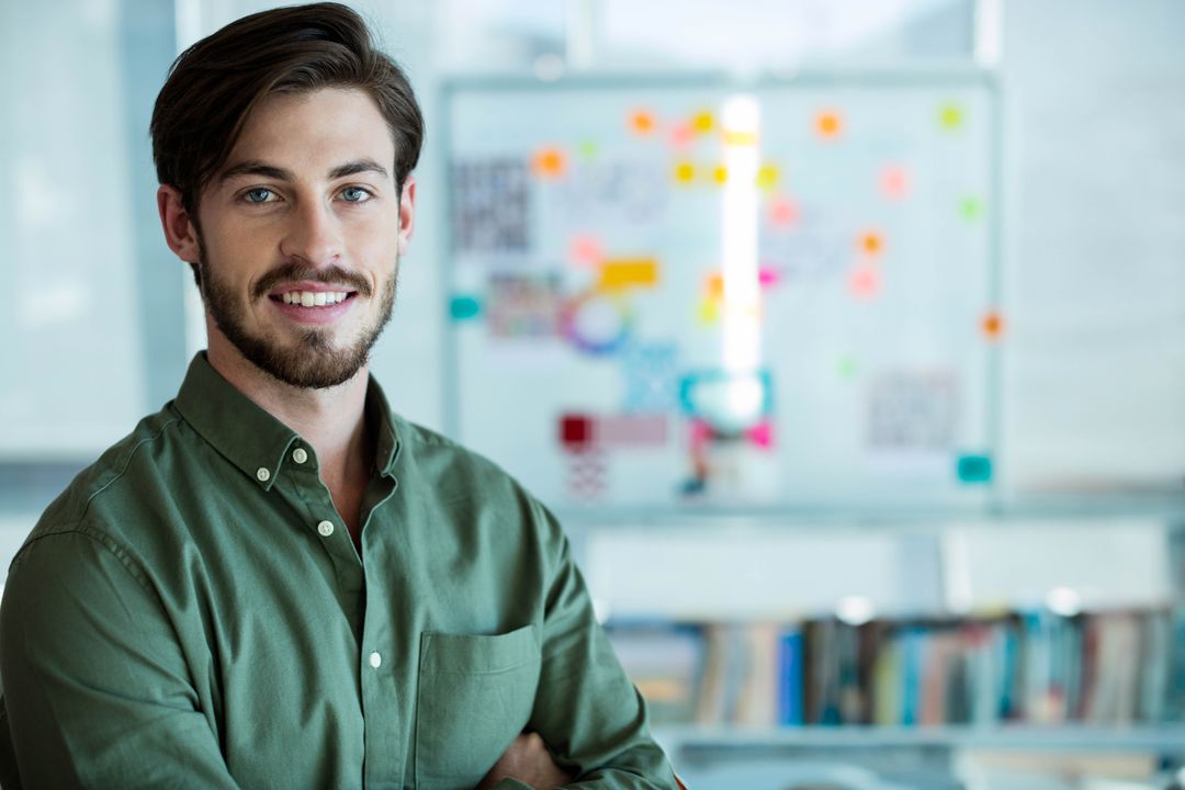 Confident Professional Man Smiling in Modern Creative Workspace