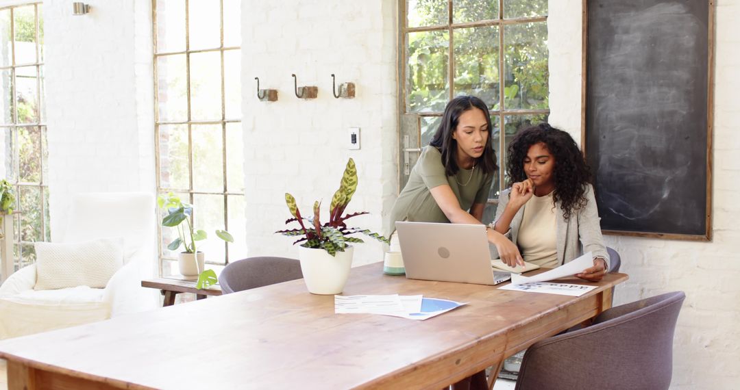 Diverse Team Analyzing Business Documents in Modern Office