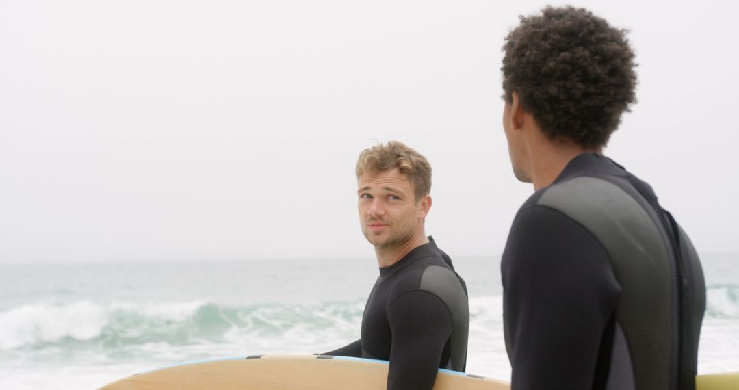 Surfers Conversing by Ocean's Edge