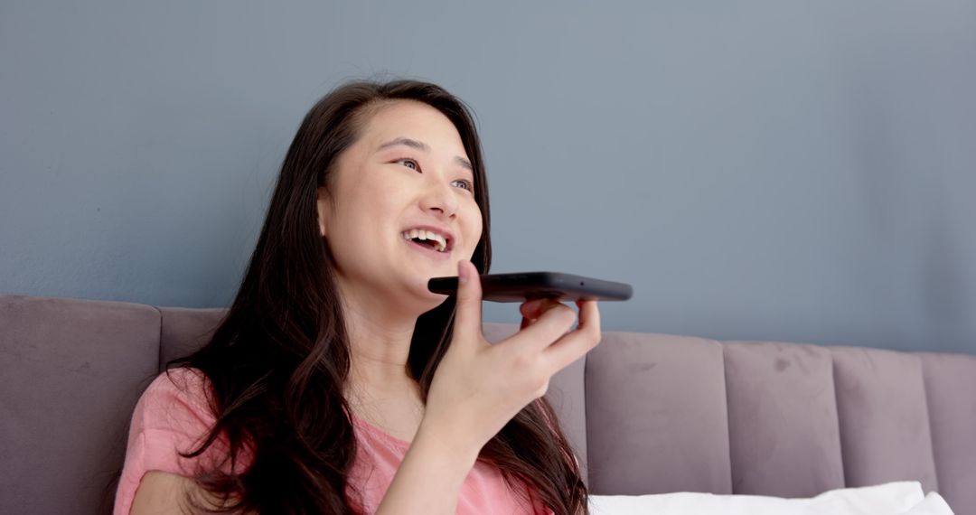 Woman Relaxing in Bedroom While Using Smartphone for Communication