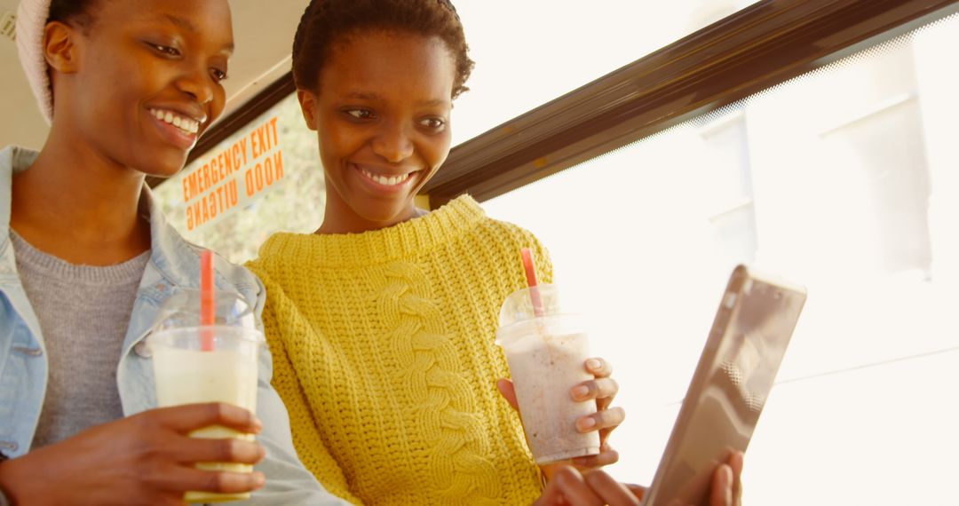 Joyful Twin Sisters Enjoying Smiling Selfie on Bus