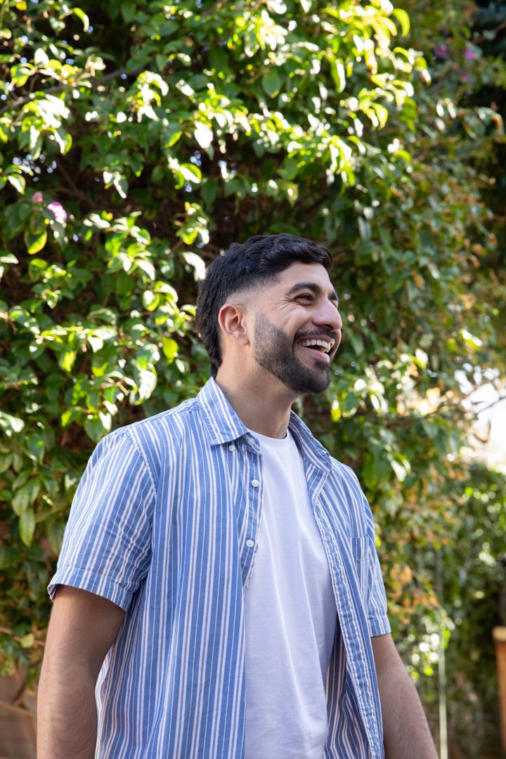 Happy Man Enjoying Relaxing Moment Outdoors in Greenery