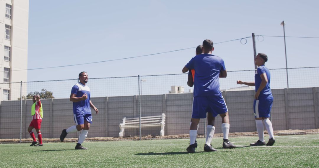 Soccer Team Celebrating Scored Goal on Artificial Turf Field