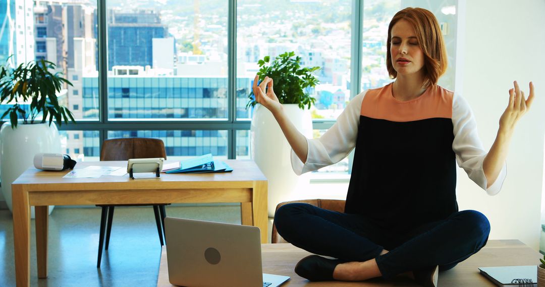 Businesswoman Meditating in Modern Office Setting - Free Images, Stock Photos and Pictures on Pikwizard.com