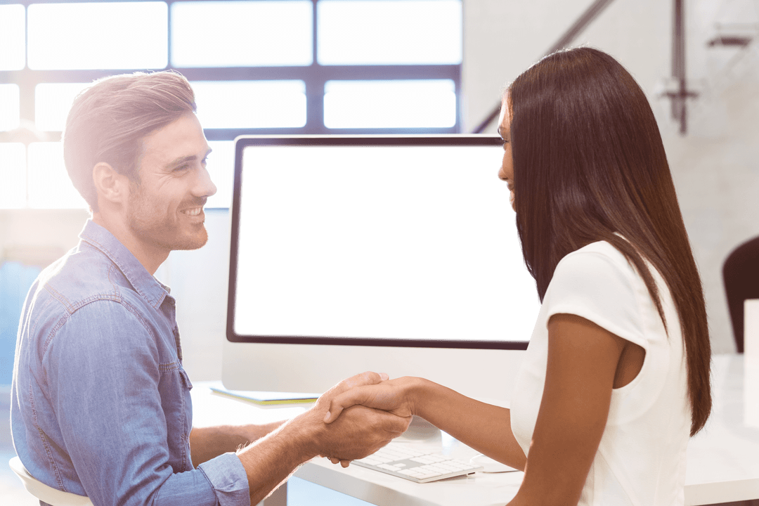 Transparent Business Handshake by Modern Office Computer