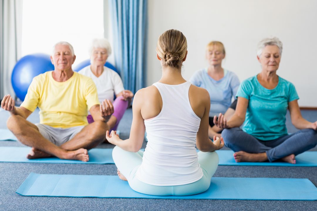 Instructor performing yoga with seniors - Free Images, Stock Photos and Pictures on Pikwizard.com