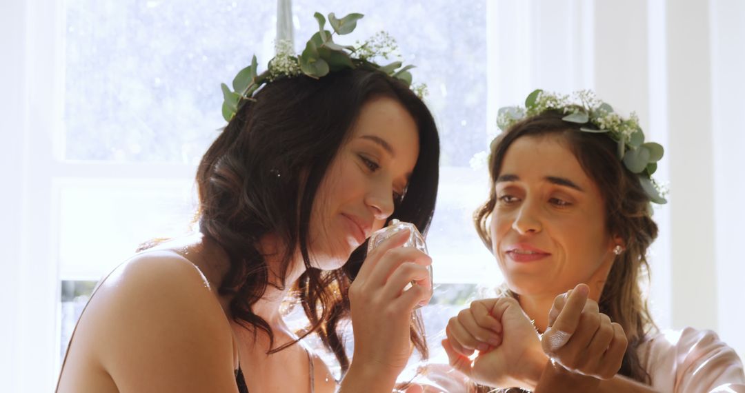 Two Bridesmaids Sharing Perfume Moment on Wedding Day - Free Images, Stock Photos and Pictures on Pikwizard.com