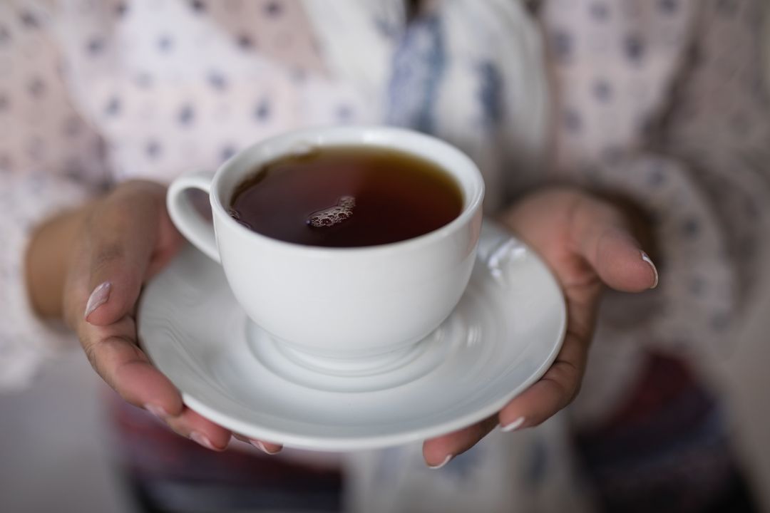 Mid section of woman holding tea cup - Free Images, Stock Photos and Pictures on Pikwizard.com