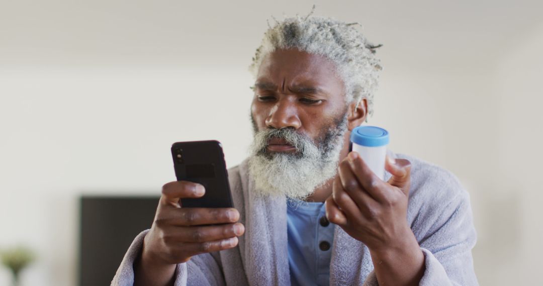 Worried Older Man Checking Medication Instructions on Smartphone - Free Images, Stock Photos and Pictures on Pikwizard.com