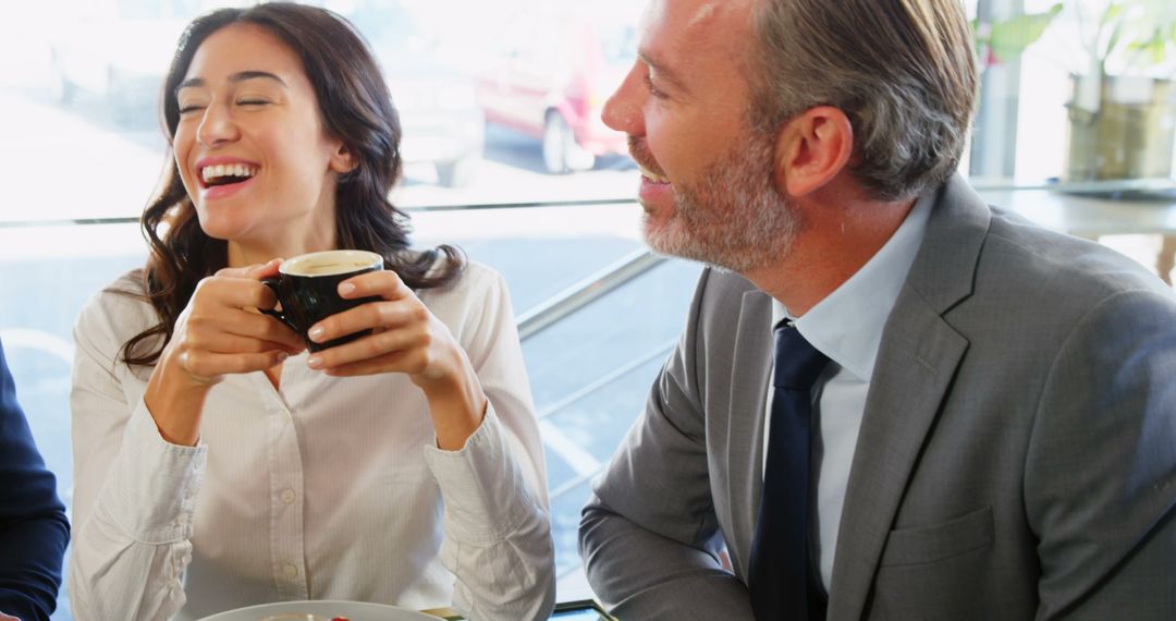 Smiling Friends Enjoying Coffee Together in Cafe Moment