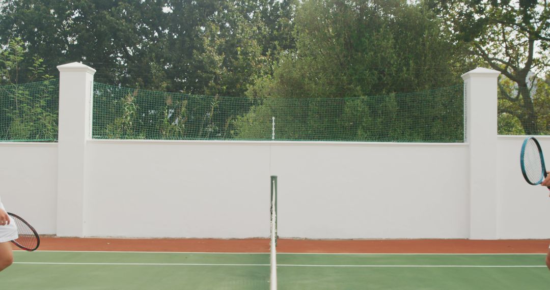 Tennis Players on Outdoor Court with Green Fence - Free Images, Stock Photos and Pictures on Pikwizard.com