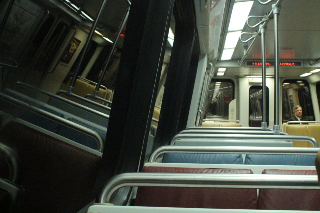 Empty Metro Train Interior With Passenger in Distance - Free Images, Stock Photos and Pictures on Pikwizard.com