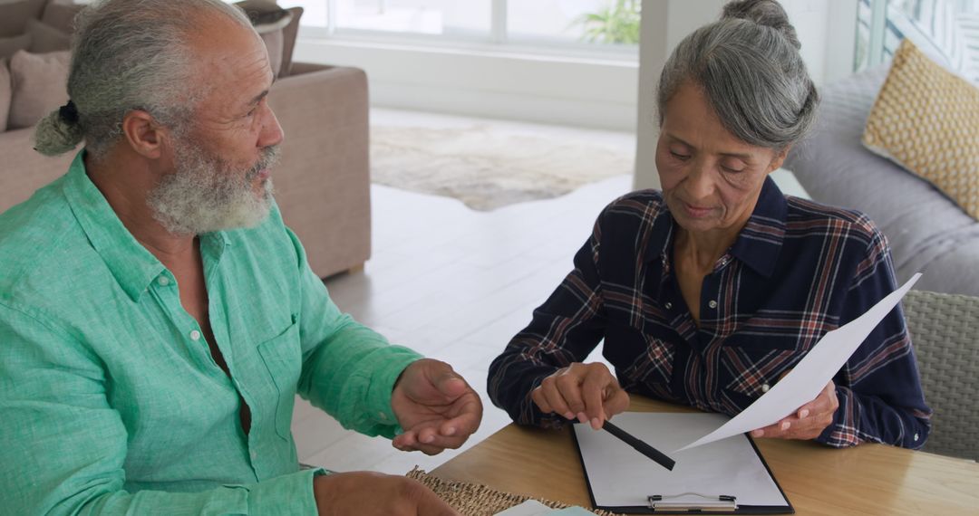 Senior Couple Reviewing Documents Together at Home - Free Images, Stock Photos and Pictures on Pikwizard.com