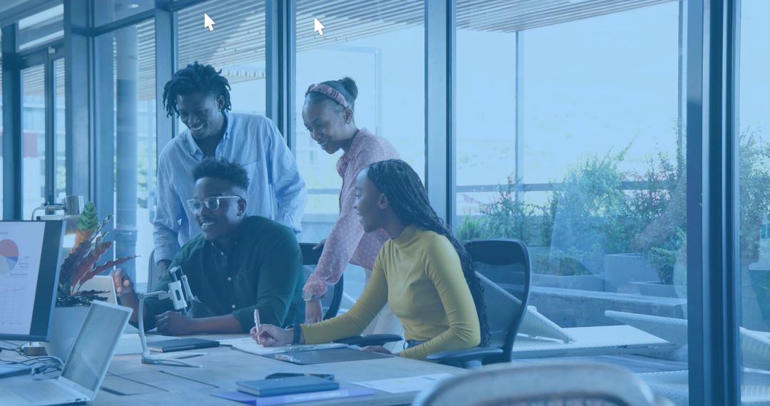 Collaborating team brainstorming around laptop and analytics chart in modern glass office