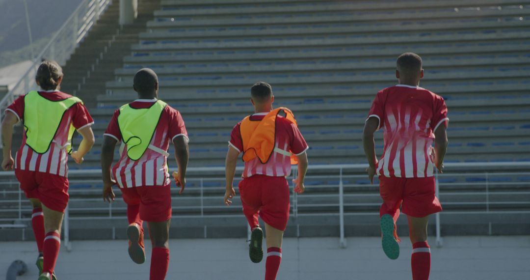 Soccer Players Running Toward Stadium Seats During Practice - Free Images, Stock Photos and Pictures on Pikwizard.com