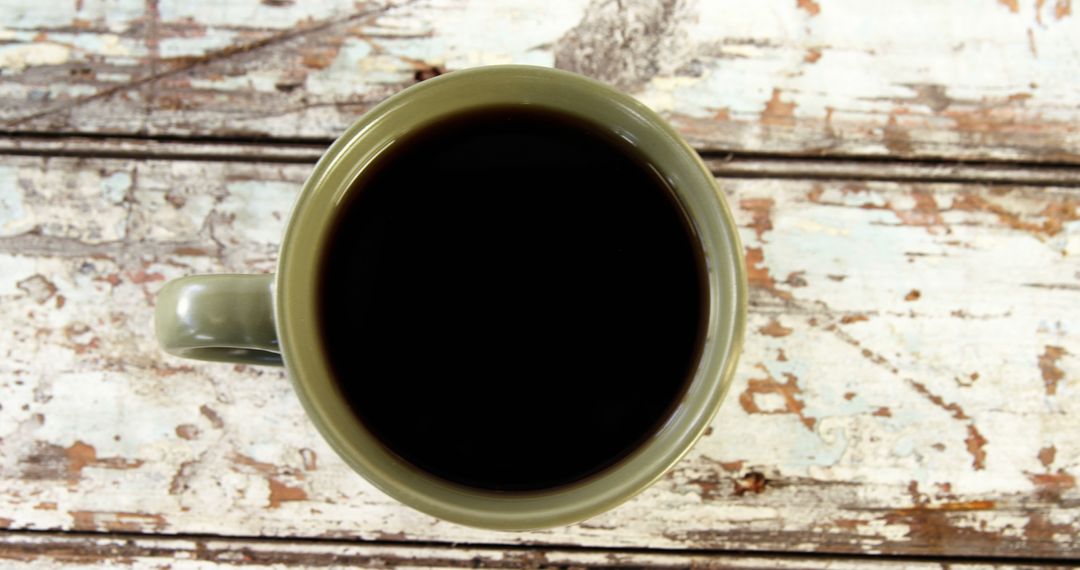 A top-down view of a full cup of coffee on a rustic wooden table, with copy space - Free Images, Stock Photos and Pictures on Pikwizard.com