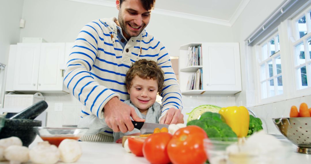 Father and Son Preparing Vegetables Together in Kitchen - Free Images, Stock Photos and Pictures on Pikwizard.com