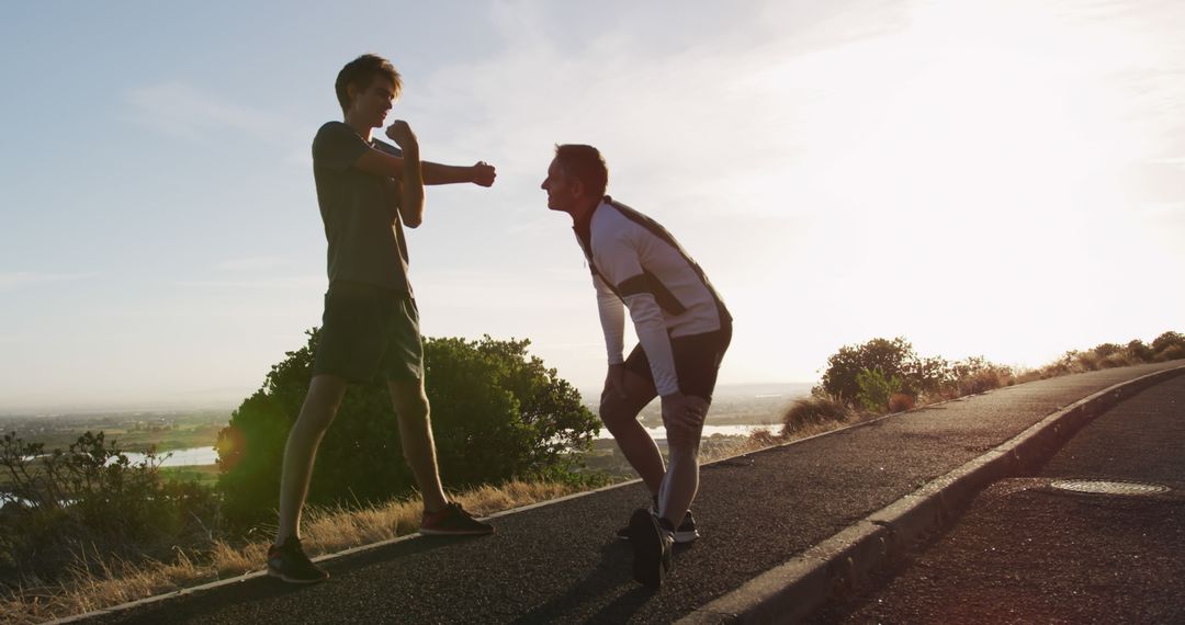 Two Men Exercising Outdoors during Sunrise in Scenic Area - Free Images, Stock Photos and Pictures on Pikwizard.com