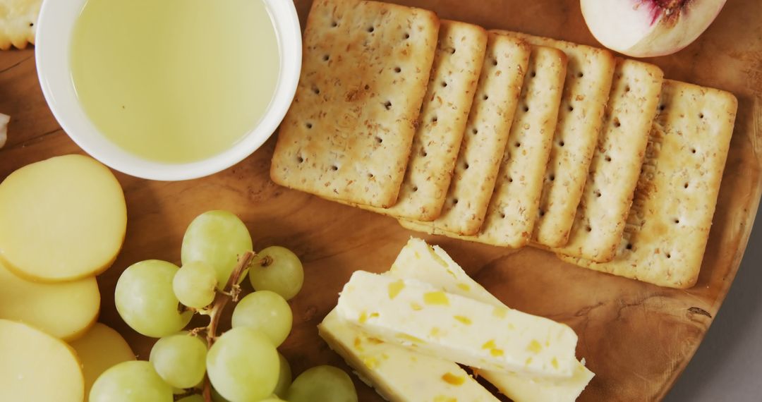 Elegant Cheese and Cracker Platter with Grapes and Olive Oil