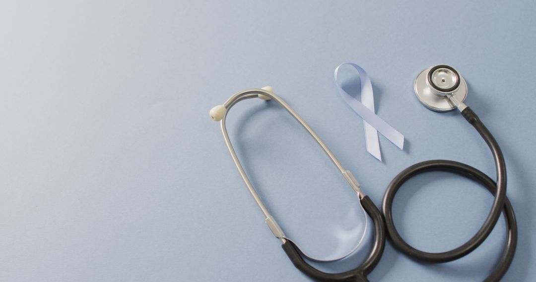 Image of stethoscope and pale blue prostate cancer ribbon on pale blue background - Free Images, Stock Photos and Pictures on Pikwizard.com