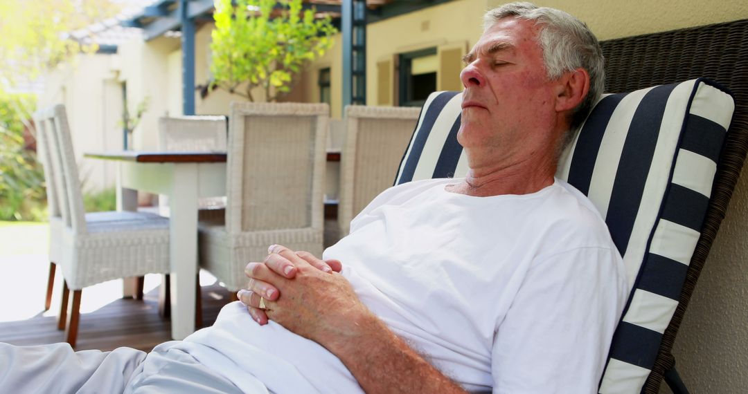 A senior Caucasian man is relaxing on a patio chair with his eyes closed, with copy space - Free Images, Stock Photos and Pictures on Pikwizard.com