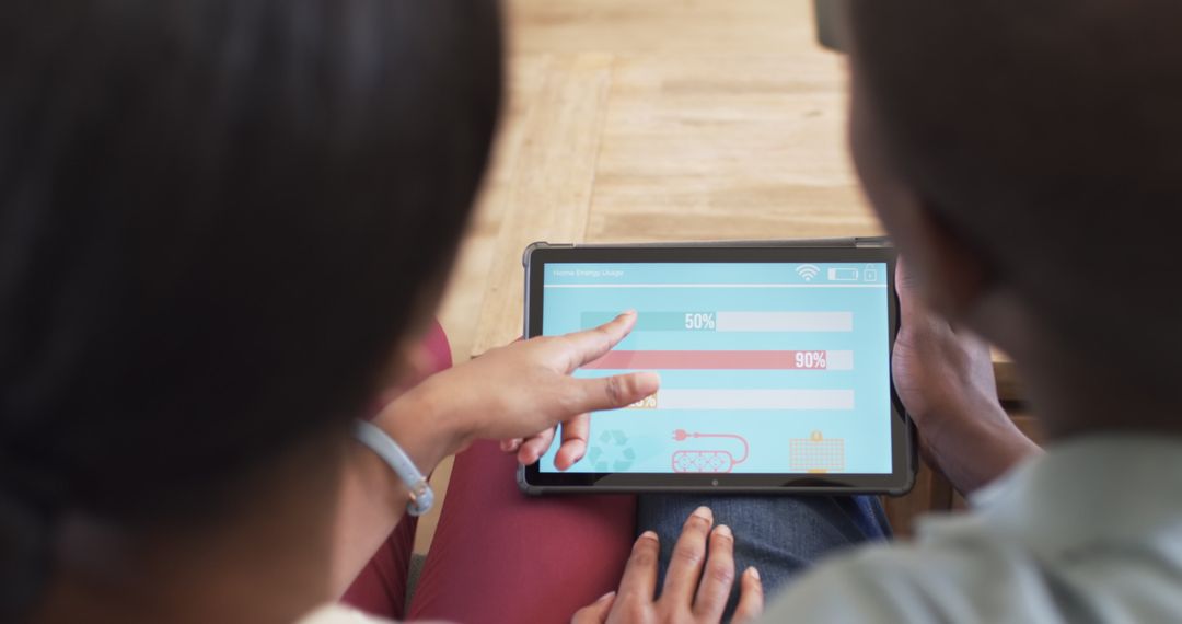 Couple Reviewing Smart Home Energy Usage on Tablet
