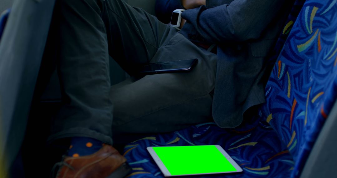 Businessman Sitting on Bus Using Digital Devices with Green Screen Tablet - Free Images, Stock Photos and Pictures on Pikwizard.com