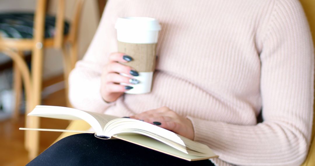 Person relaxing with a book and takeaway coffee cup at home - Free Images, Stock Photos and Pictures on Pikwizard.com