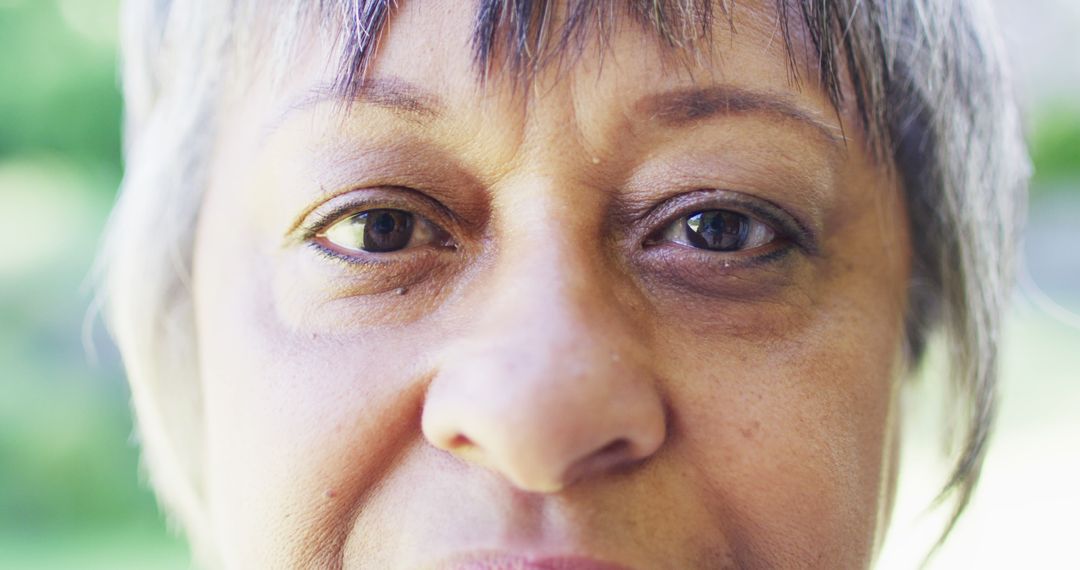 Close-Up of Mature African American Woman with Short Hair Looking at Camera - Free Images, Stock Photos and Pictures on Pikwizard.com