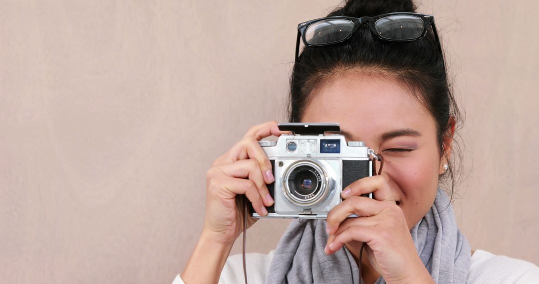 Young Woman Taking Photograph with Vintage Film Camera - Free Images, Stock Photos and Pictures on Pikwizard.com