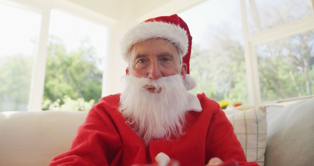 Senior Man in Santa Claus Outfit Sitting at Home - Free Images, Stock Photos and Pictures on Pikwizard.com